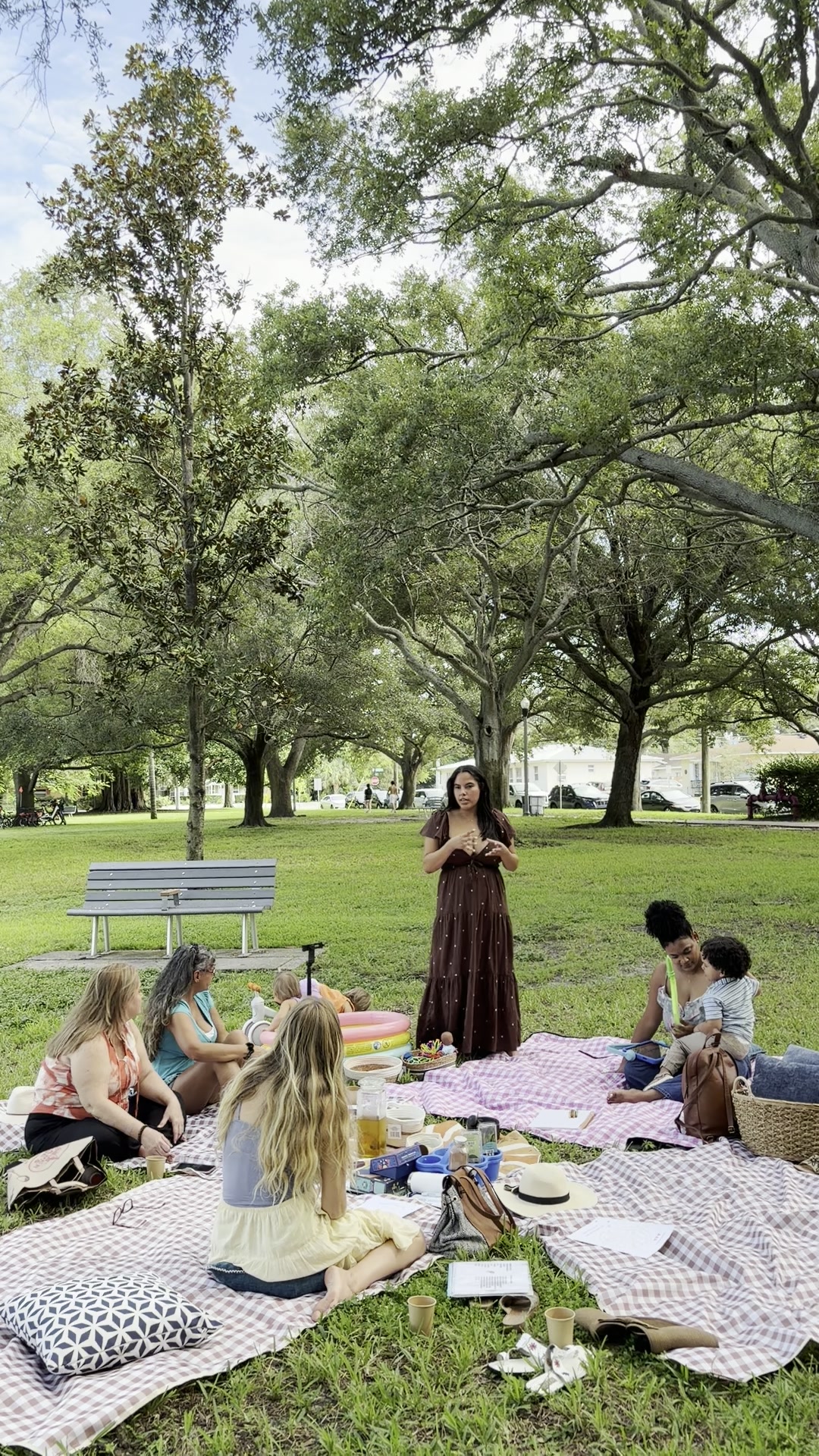 Andrea speaking to the group on picnic blankets at Crescent Lake